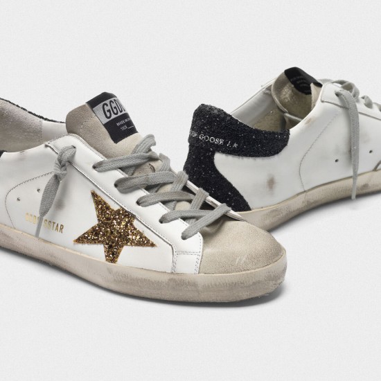 Women Golden Goose superstar with gold star and glittery black sneaker